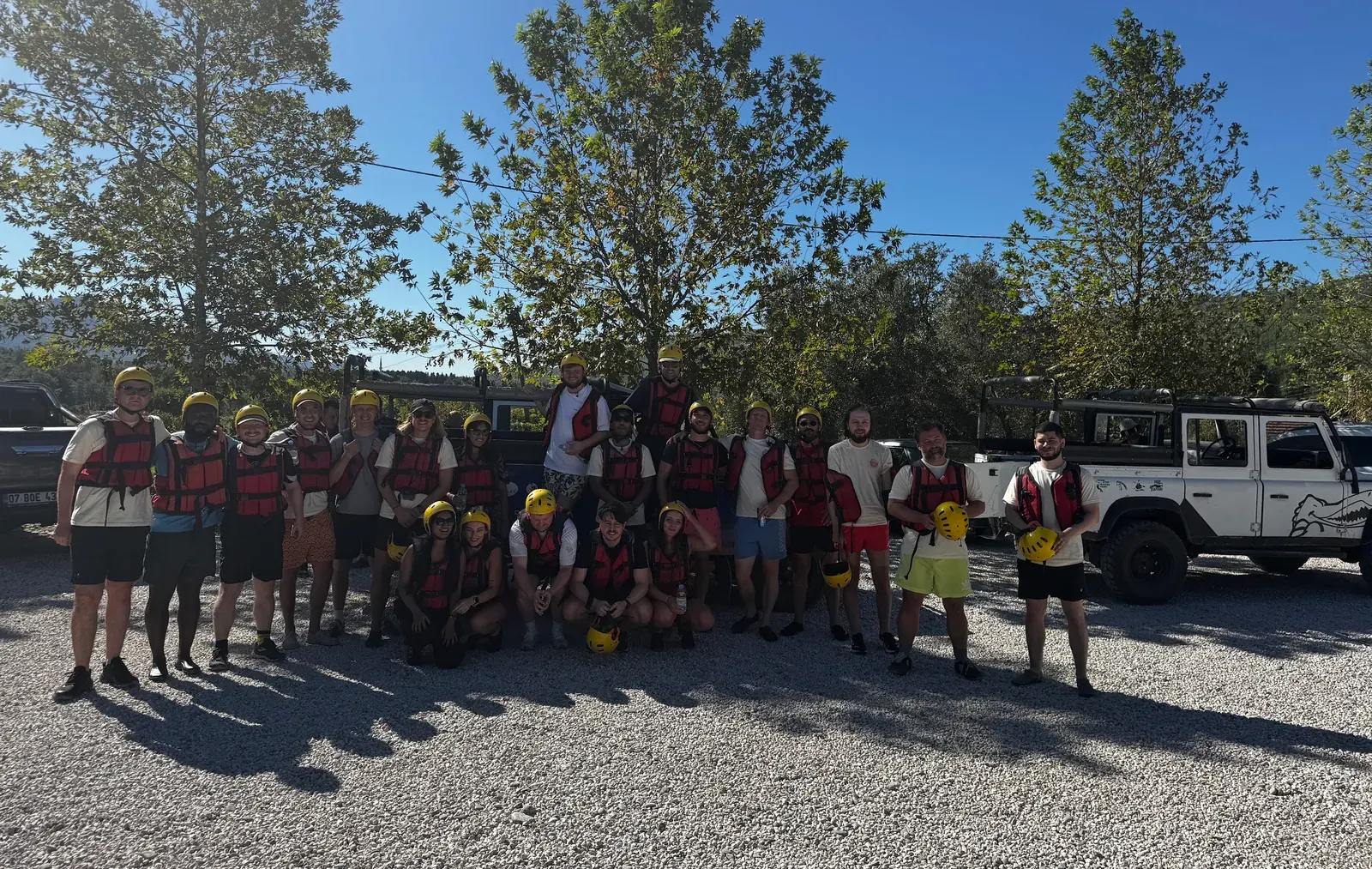 The team in life jackets and helmets before going rafting