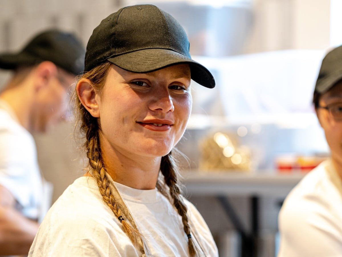 image of smiling young woman serving customers