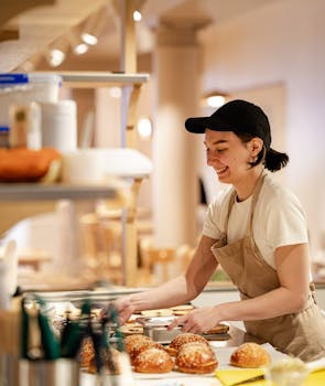 Young lady in a kitchen visibly preparing food.