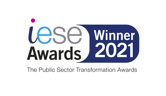 A logo with text: "iese Awards" and "Winner 2021" on a blue background, with more text underneath: "The Public Sector Transformation Awards".