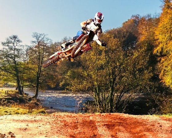 Image of a motocross biker mid-air during a jump.
