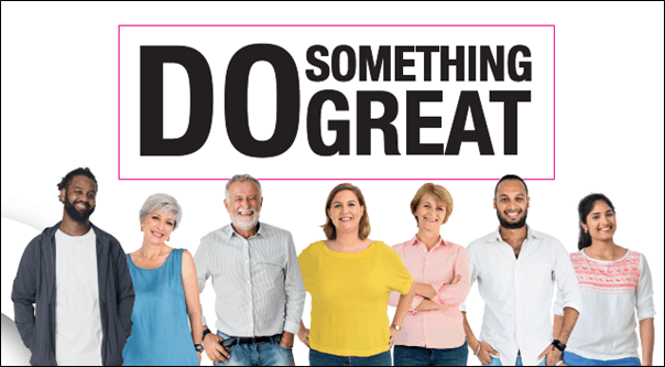 a group of smiling foster parents standing in front of a sign that reads "do something great"