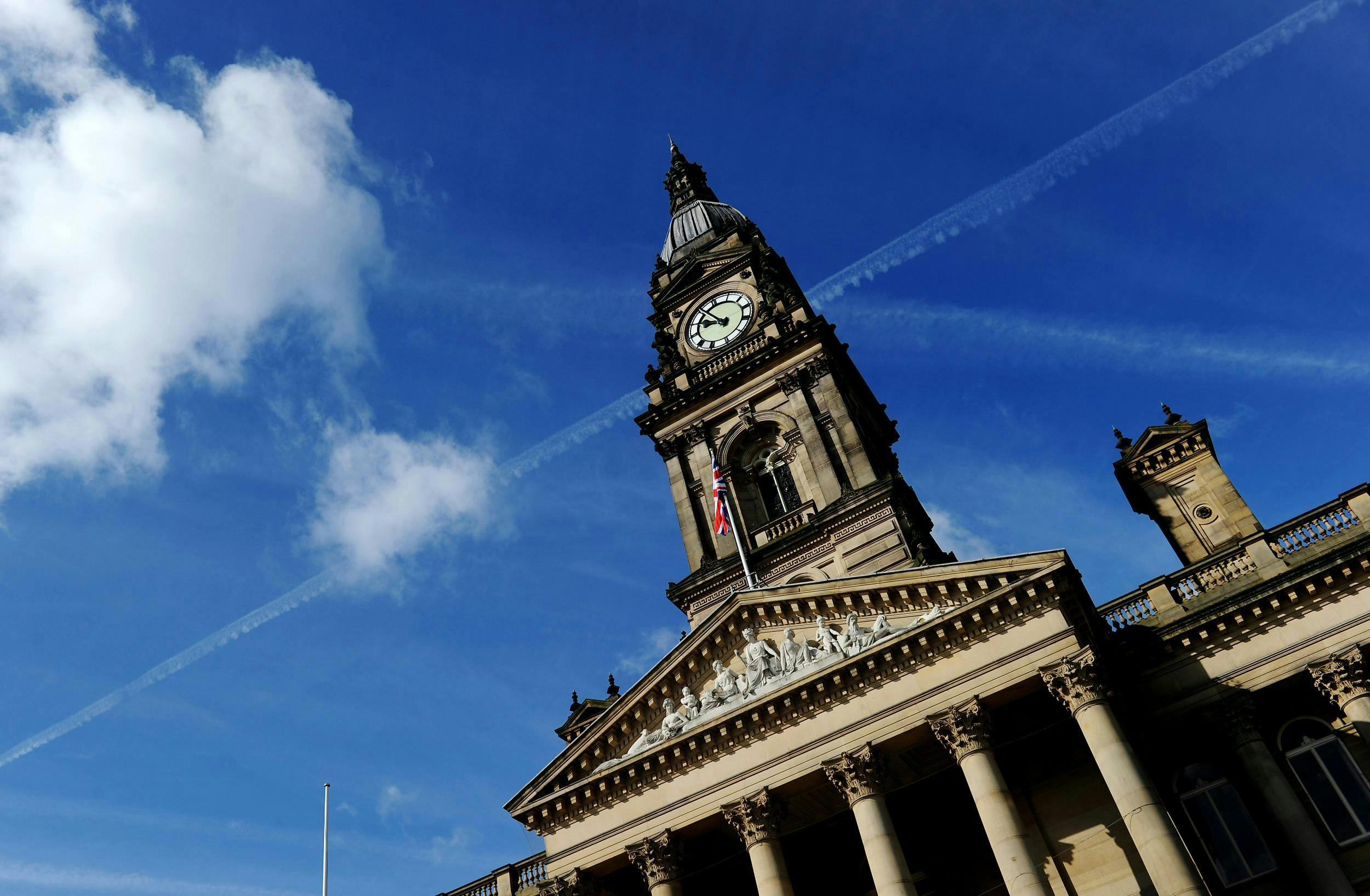 Image of Bolton town hall on a sunny day with the union jack flying