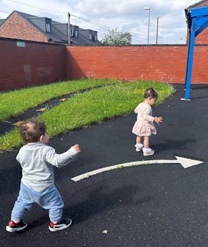 Image of two kids playing in a yard.